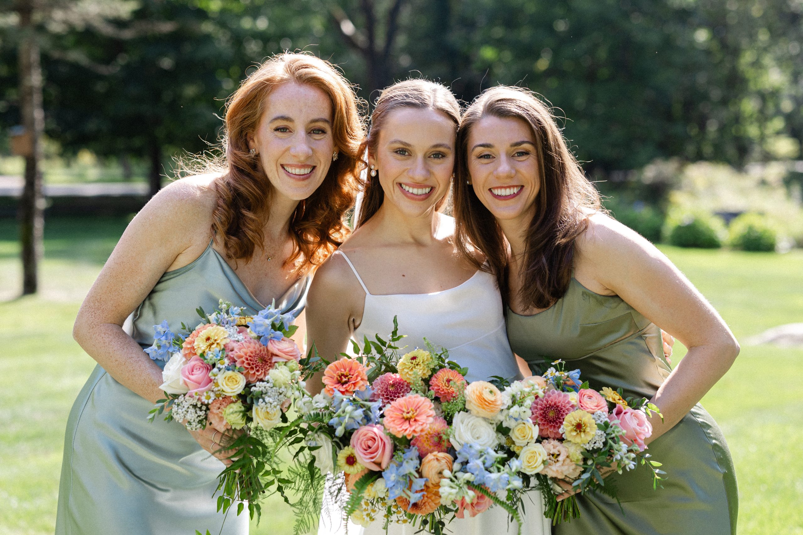 Bride and bridesmaids wearing natural makeup outside of Boston